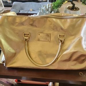 Michael kors gold duffle bag